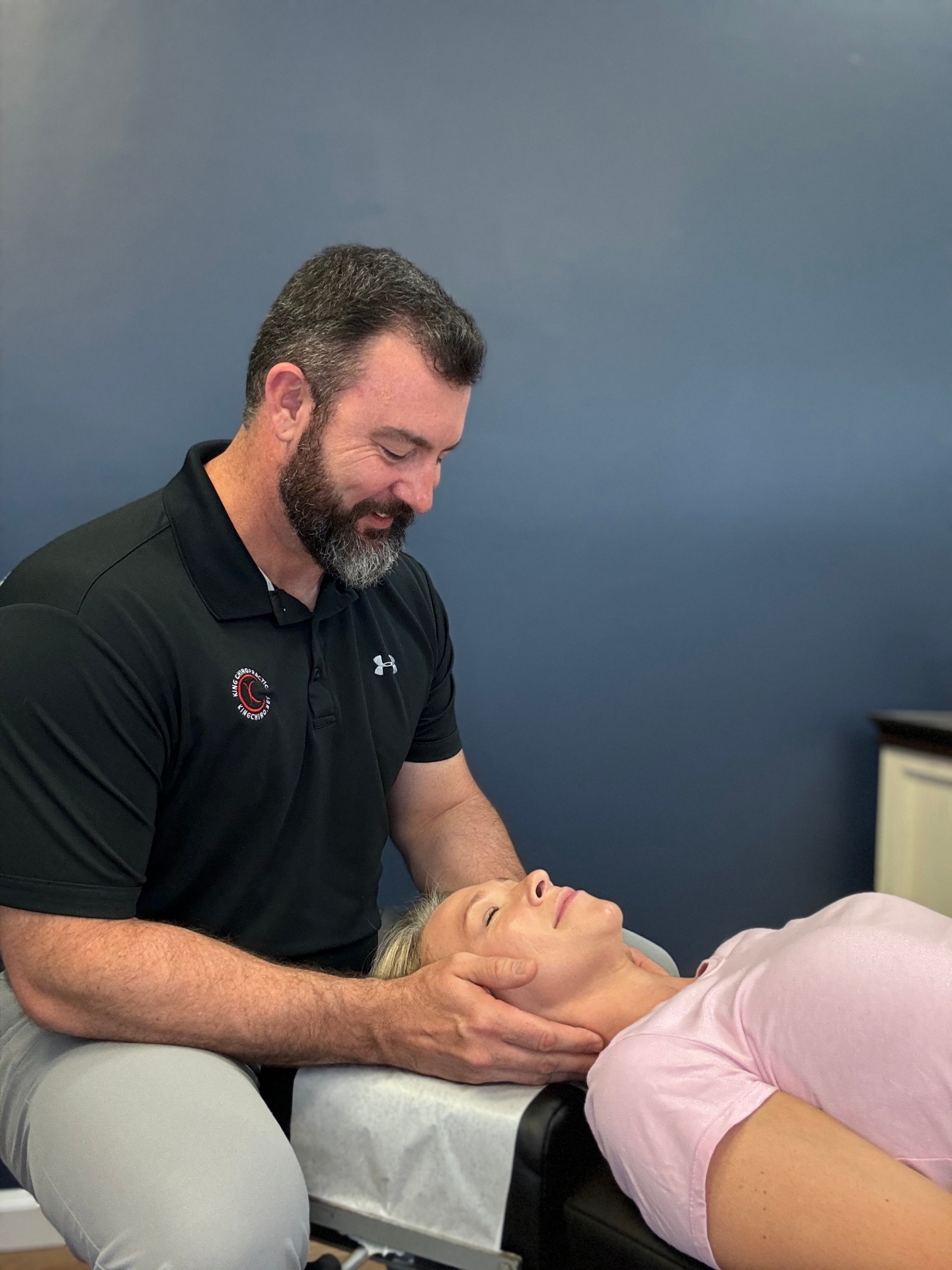 Dr. King supporting a patient's neck during a cervical adjustment
