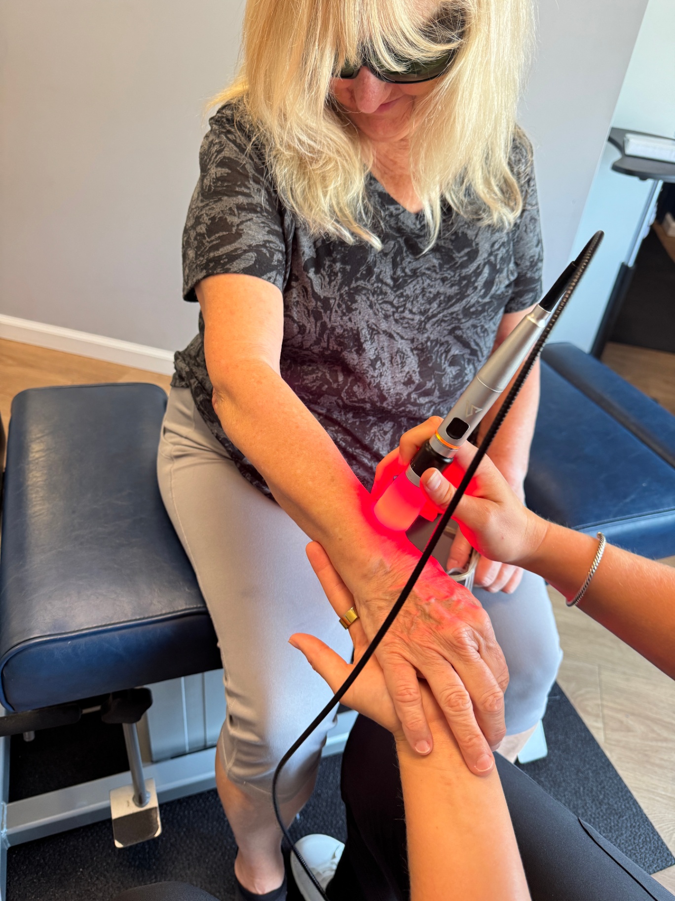 Medical laser therapy on a patient's hand