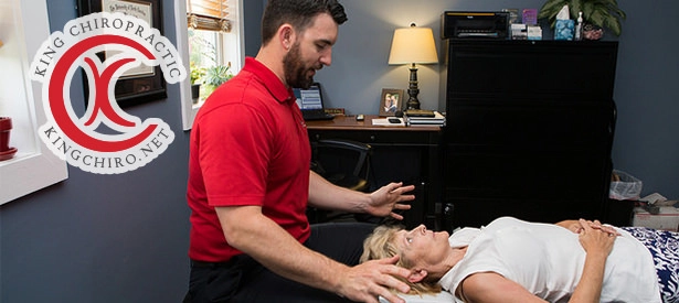 Chiropractor Wilmington NC Rhett King Adjusting Woman's Neck In Office